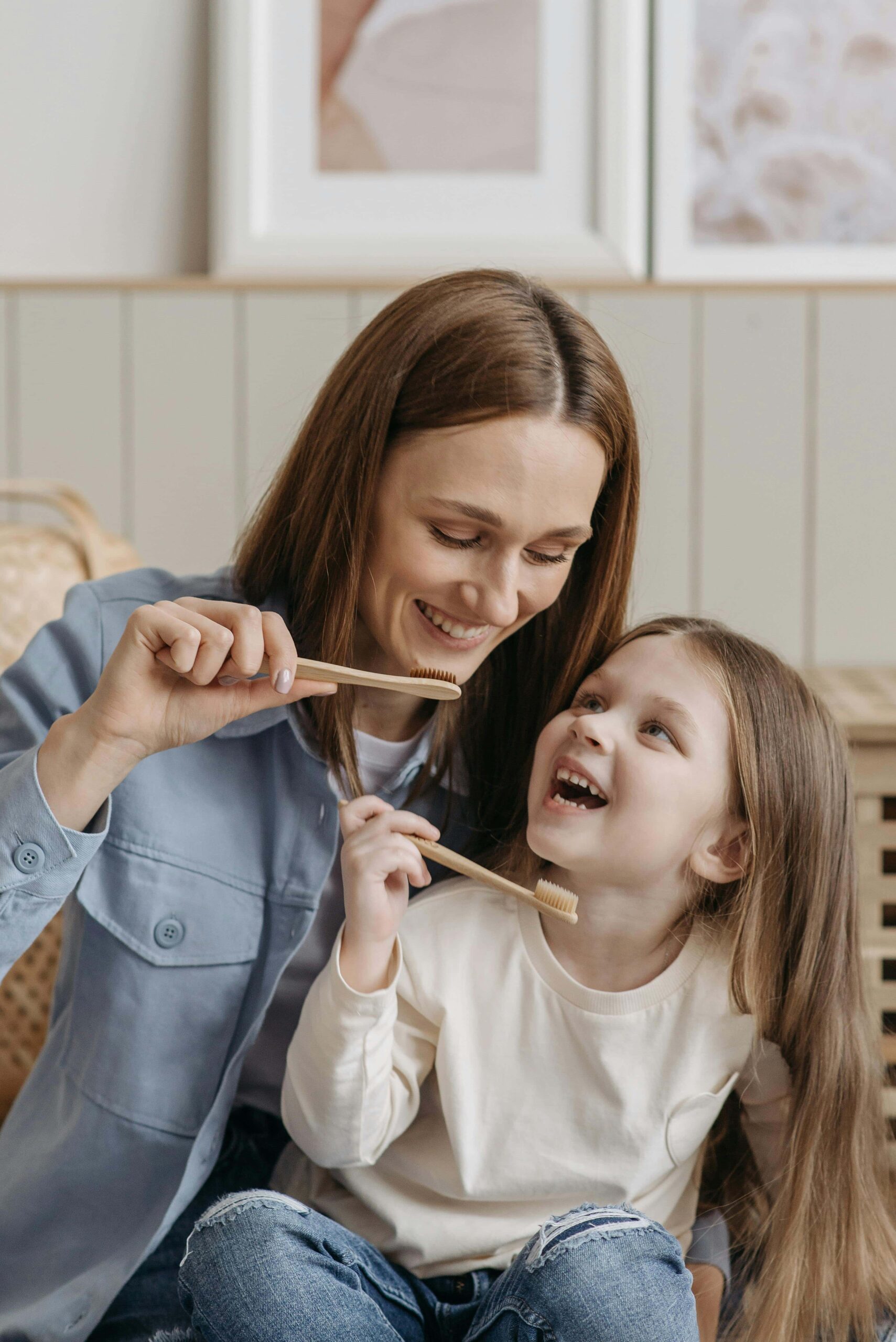 mom daughter brushing teeth